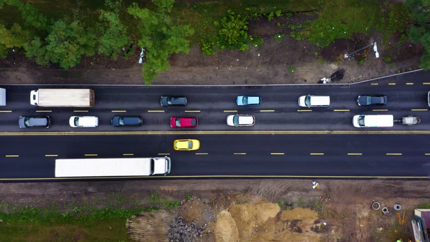 Aerial view. Traffic jam in a big city. Rush hour. Kiev, Ukraine. Car traffic jam. Aerial Drone Flight top down View of freeway busy city. Aerial vertical, vertical video background. 