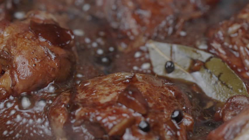 filipino adobo chicken thighs and chicken legs simmering in dark glaze sauce. Royalty-Free Stock Footage #1107777559