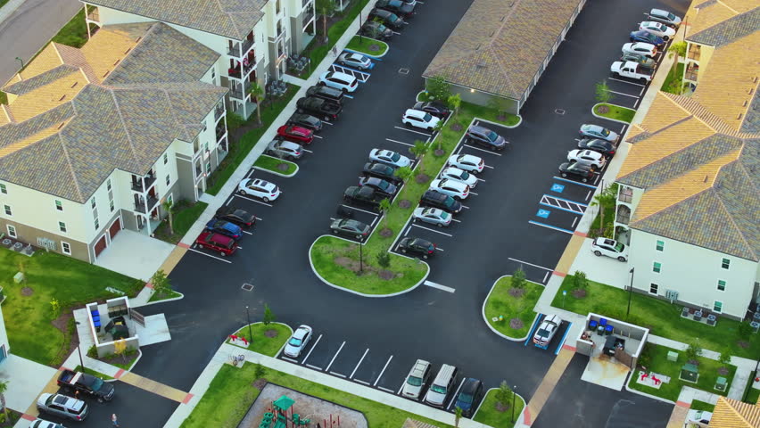 Apartment residential condos with car parking place in Florida suburban area. American condominiums as example of real estate development in USA suburbs Royalty-Free Stock Footage #1107778997