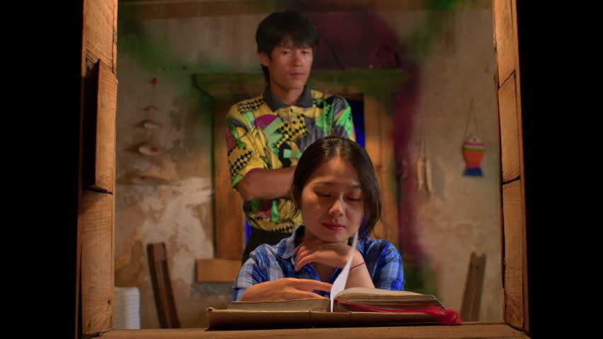 male thai boyfriend approach his asiatic gf from behind covered her eyes making a surprise, slow motion window framed 