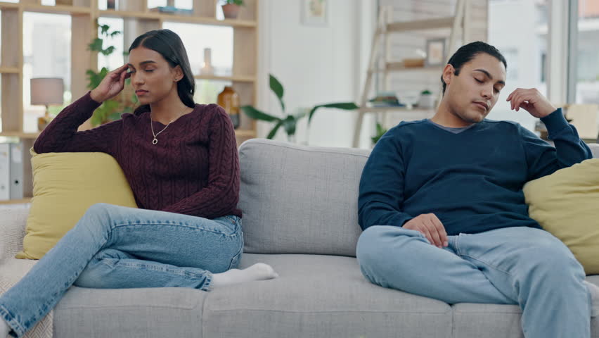 Couple, separation and conflict on sofa in fight, argument or divorce discussion in living room with angry, dispute or disagreement. Frustrated, woman and man with confession of cheating or mistake Royalty-Free Stock Footage #1107780639