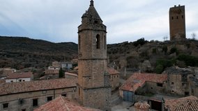 Panoramic drone view of old medieval Romanesque church of San Cristobal and view of surrounding area of Luzas, a perfect example of landscaped ancient architecture. Huesca, Aragon, Spain. 4K video