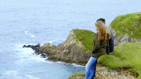 Young couple in love at the Irish west coast - slow motion clip 