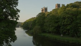 Stunning wide clip of River Wear and Durham Cathedral on a beautiful spring evening