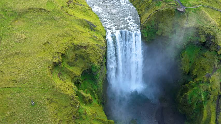 Aerial view of the Skogafoss waterfall, Iceland, flying above with a drone