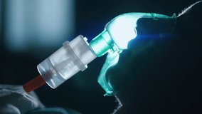 A female patient in medical mask is breathing oxygen support in a hospital next to heart rate machine. Unhealthy woman in coma. Getting mechanical ventilation. Concept of pandemic and therapy. - Powered by Shutterstock - Get 15% off with code: PIKWIZARD15