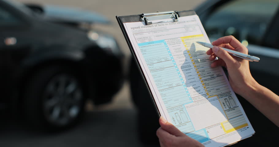 Close up of a woman car insurance agent inspecting damaged car with agreed statement of facts on motor vehical accident form. Female filling in a car repair claim. Insurance concept. Royalty-Free Stock Footage #1107807045