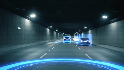 Inside view a moving autonomous self-driving car vith HUD elements driving through a tunnel, scanning the surrounding cars and road with a sensor. Concept of the smart transort of the future. 4k  스톡 비디오