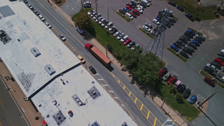 Aerial View of a Container Truck Driving Through Downtown Halifax, Passing Pedestrians at Intersections, and Heading to the Seaport to Load Cargo and Goods.