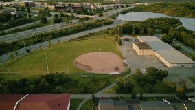 Cinematic drone shot on baseball field with players. Male and female baseball players in action during a game in a baseball stadium. Baseball field with players in uniform playing the game. - Powered by Shutterstock - Get 15% off with code: PIKWIZARD15