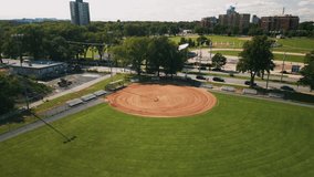 Cinematic drone shot on baseball field with players. Male and female baseball players in action during a game in a baseball stadium. Baseball field with players in uniform playing the game. - Powered by Shutterstock - Get 15% off with code: PIKWIZARD15