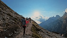 Active people with backpacks hiking trail path and climbing Dolomites mountain.Group of friends summer adventure journey in nature outdoors. Travel exploring Alps, Dolomites, Italy - Powered by Shutterstock - Get 15% off with code: PIKWIZARD15