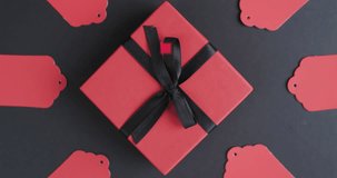 Animation of cyber monday sale text over gift tags and boxes. Sales, retail, cyber shopping, digital interface, communication, computing and data processing concept digitally generated video.