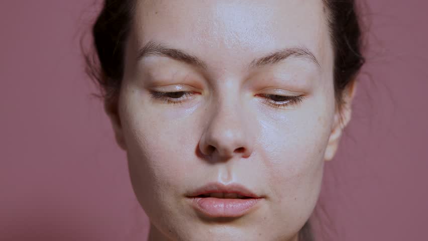 Shoot with a smartphone camera. A young woman points her phone to take a photo or video .looking into the camera from under the smartphone