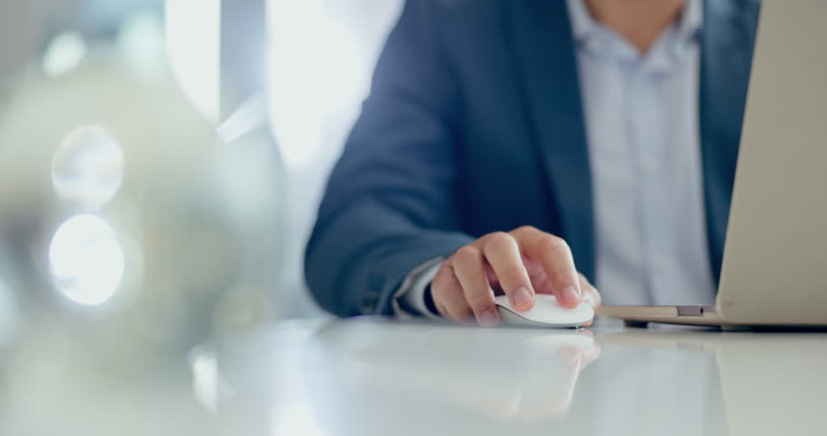 Hands, man and business professional with mouse on office desk working on research project, report or proposal. Person, laptop and entrepreneur with technology for web, internet and productivity