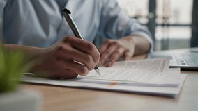 Close up unrecognizable man businessman writing paperwork report on desktop male hands signing business documents on office table student write educational test english exam studying in university  - Powered by Shutterstock - Get 15% off with code: PIKWIZARD15