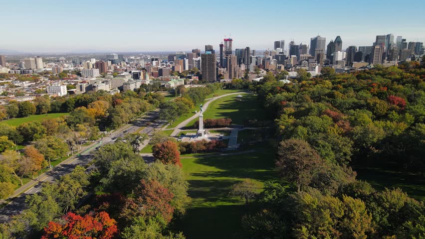 Aerial view of road in old district in Montreal. Drone footage of city, Montreal, Canada at autumn. Downtown cityscapes. View of Mont Royal mountain park.  Drone footage on sunset.