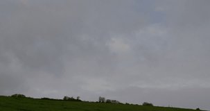 Animation of multiple graphs and trading boards over windmill on green field against cloudy sky. Digital composite, multiple exposure, report, business, stock market, green and sustainable energy. - Powered by Shutterstock - Get 15% off with code: PIKWIZARD15
