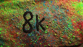 Slow motion video 4k 1000fps ink detail studio shoot TV sign 8k.Powerful explosion of multi colored powder word or number 8k.Concept word text television 8K resolution display future creativity ideas