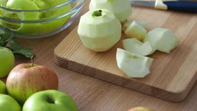 Peeled green garden apples. Sliced apples for pie. Ingredients for home baking. Autumn mood to cook homemade, hot food. Apples on a cutting board top view