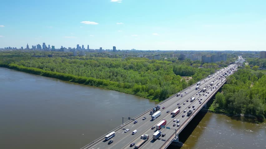 Aerial view of traffic moving on a massive bridge over the Vistula River in Warsaw. Highway passes through the river and leads to the center of Warsaw, Poland.