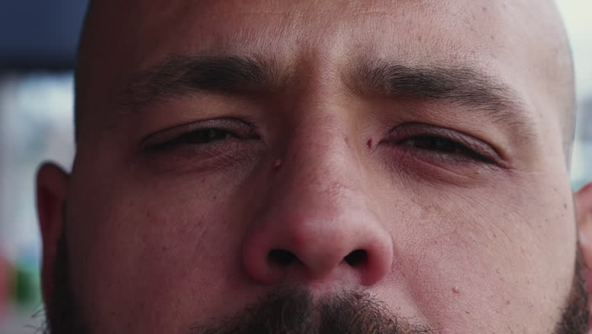 Macro Close-Up of Man's Face with Judgemental Expression, Serious and Upset Male Person