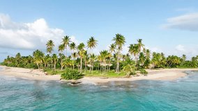 View of a beautiful tropical island in the ocean with a sandy palm beach. Coast of the Caribbean. Vacation and vacation concept. Tropical beach against a blue cloudy sky. The best beach in the world.