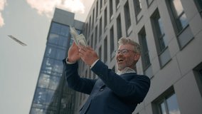 Caucasian rich wealthy old male business success employer entrepreneur businessman senior retired mature man money rain financial successful cash throw banknotes in air outdoors in city salary winning - Powered by Shutterstock - Get 15% off with code: PIKWIZARD15
