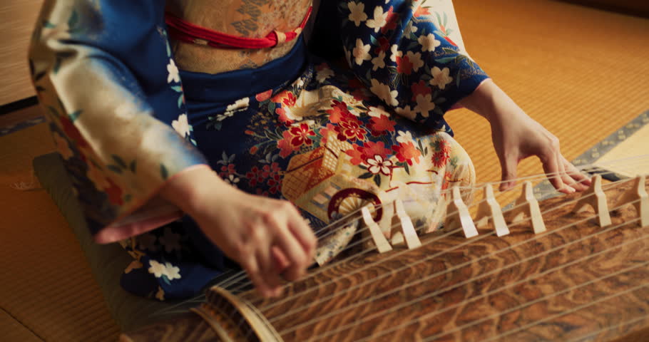 Close Up Portrait of a Focused Adult Female Playing on a Traditional Japanese Toto Instrument. Musician Wearing a Beautiful Kimono, Performing a Classical Solo Concert Indoors in Japan Royalty-Free Stock Footage #1107842635