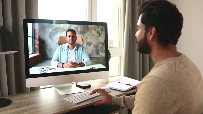 Business meeting on the distance. Indian man using computer app for video connect with male colleague. Multiracial guy talking with coach online | Shutterstock HD Video #1107845685