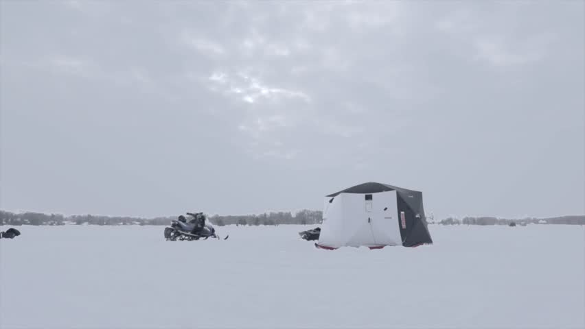 A time-lapse shot of a fishing hut on a frozen lake