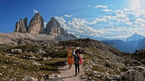Active people with backpacks hiking trail path and climbing Tre Cime di Lavaredo Dolomites mountain. Group of friends summer adventure journey in nature. Travel exploring Alps, Dolomites, Italy
 - Powered by Shutterstock - Get 15% off with code: PIKWIZARD15