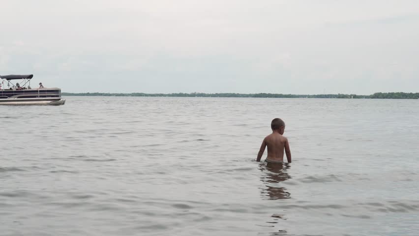 A caucasian boy in a lake water in Orillia, Canada