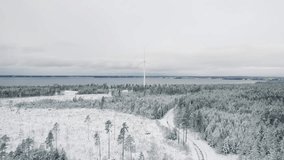 A gray landscape scene of a windmill on forest trees by a lake with cloudy sky - Powered by Shutterstock - Get 15% off with code: PIKWIZARD15