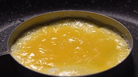 Close-up yolk of an egg is fried in mold in a frying pan. High quality FullHD footage