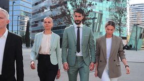 Slow motion fotage of successful executive business people walking on downtown workplace with serious expression. Front view of corporate businesspeople or colleagues with determination and ambition - Powered by Shutterstock - Get 15% off with code: PIKWIZARD15