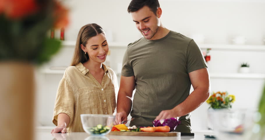 Vegetables, cooking and couple in the kitchen together for bonding with gourmet recipe. Happy, smile and young man and woman cutting ingredients for preparing a dinner, supper or lunch meal at home. Royalty-Free Stock Footage #1107862471