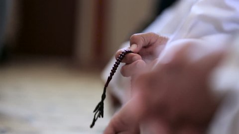 Muslim man use his prayer beads inside mosque at Amerli, Iraq. Amerli steadfastness to ISIS was a turning point in the war between Iraqi government and ISIS