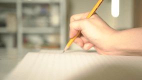 Pencil writing studying close-up hand on a note paper wooden calligraphy letters education drawing handwriting student children kids school home background  - Powered by Shutterstock - Get 15% off with code: PIKWIZARD15