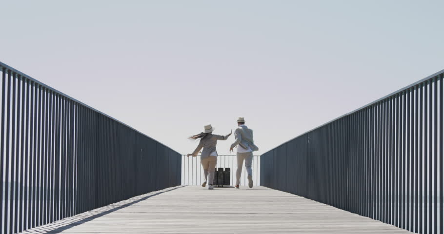 Two young people walking together on bridge road with lake view