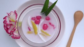 Tub Tim Krob Thai traditional dessert Crispy Ruby in coconut milk. Sweet taste eat with ice for freshness. 4k video