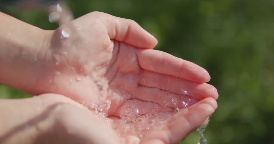 Water flows in the palms of the hands. Drink spring water from your hands. Clean water flows out. Royalty-Free Stock Footage #1107871063