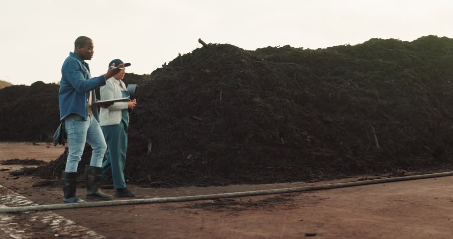 Compost business, walking and agriculture people with clipboard for collaboration. Discussion of team for back of organic waste plant, dirt fertilizer or recycle pile at soil management inspection