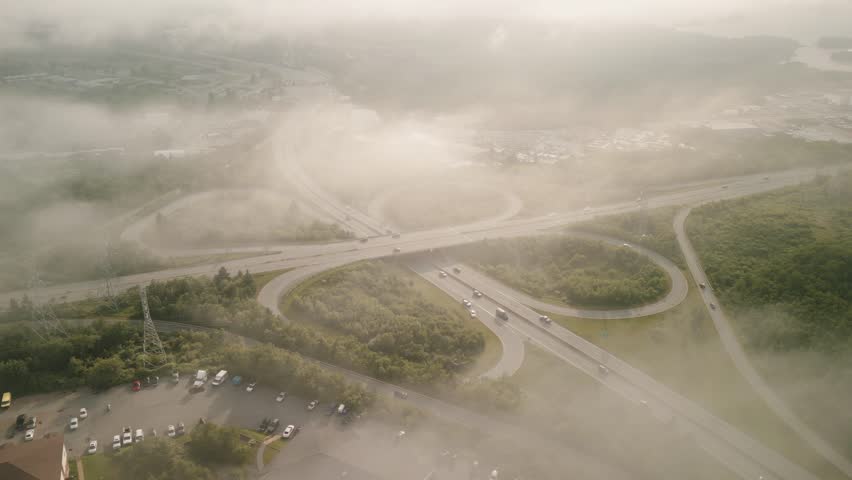 Aerial View of a Busy Freeway on a Foggy Day from the City of Dartmouth, Canada. Drone shot of Flyover or Overpass. Poor Visibility for Car Drivers, Driving in Fog at a Freeway Junction. 