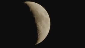 Half Moon moves through the night sky, closeup detailed video.
