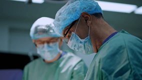 Professional surgeons focused on performed operation. Three cooperating doctors working together in surgical room. - Powered by Shutterstock - Get 15% off with code: PIKWIZARD15