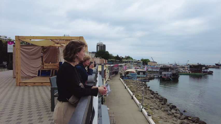 Women walking on the Black Sea coast. Russia, Anapa - May 22, 2023: The Black Sea coast of the Krasnodar Territory, Anapa district, tourists spring vacation. 
