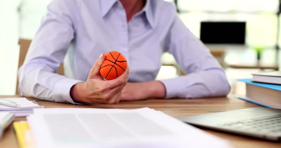 Woman squeezing an antistress ball in office closeup Royalty-Free Stock Footage #1107886285