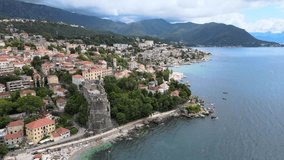 A camera drone flies ahead over a coastline of Herceg Novi and the Old Town, Montenegro