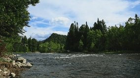 Spinning fishing on a mountain river in a beautiful landscape. Slow motion video. High quality Full HD footage
